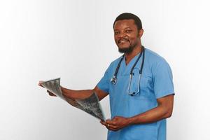 Black surgeon doctor bearded man in blue coat with crossed arms isolated white background copy space photo