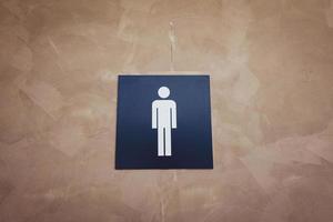 male sign in front of the toilet photo