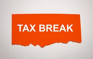 tax break on torn paper and white background photo