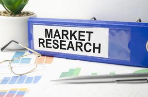market research words on blue folder and charts photo