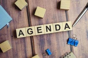 Agenda word on wooden cubes. Agenda meeting appointment activity information concept photo