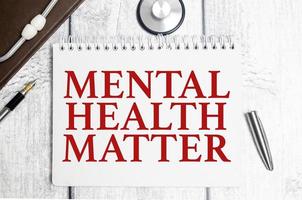 mental health matter words on notebook and stethoscope on white wooden background photo