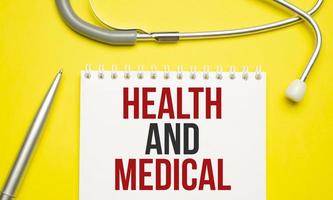 Health and Medical words on notepad and stethoscope photo