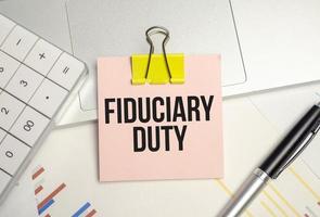 text fiduciary duty and a pink paper and calculator photo