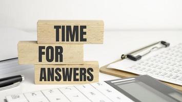 time for answers words on wooden blocks and office supplies photo