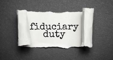 Paper with text fiduciary duty on wood table photo