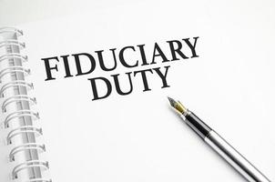 fiduciary duty words with pen and paper photo