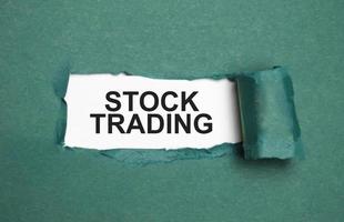 stock trading on torn paper and white background photo