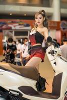 Nonthaburi, Thailand - MAR 27, 2021 Unidentified model poses with a car at The 42th Bangkok International Motor Show Thailand 2021 at IMPACT Arena photo