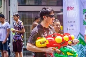 Siam Square, Bangkok, Thailand - APR 13, 2019 short action of people joins celebrations of the Thai New Year or Songkran in Siam Square. photo