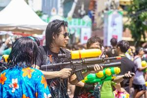Siam Square, Bangkok, Thailand - APR 13, 2019 short action of people joins celebrations of the Thai New Year or Songkran in Siam Square. photo