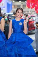 Nonthaburi, Thailand - MAR 27, 2021 Unidentified model poses with a car at The 42th Bangkok International Motor Show Thailand 2021 at IMPACT Arena photo