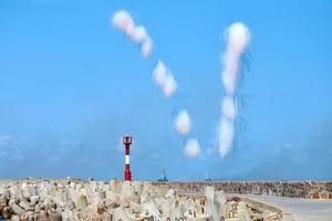 White carbon fiber clouds in blue sky hiding naval destroyers from anti-ship missiles, military show photo