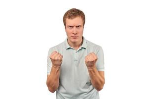 Furious young man in mint T-shirt ready to fight with fists isolated on white background photo