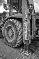 Part of excavator machines in black and white. Vertical view photo