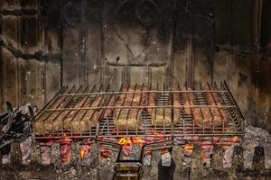 Roasting fresh meat in the fireplace. Make BBQ photo