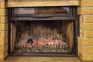 Close view of the fireplace with glowing charcoals photo