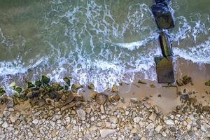 Aerial top view from drone to the seacoast and old concrete pier, Sea background. photo