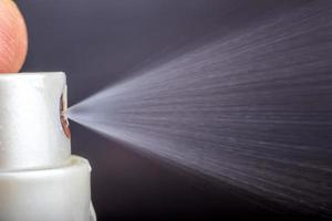 Macro shot for using a spray. Using disinfectant spray to prevent germs, bacteria or viruses photo