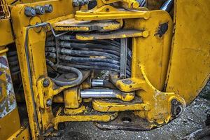 Detail of modern yellow excavator machines. Close up photo