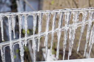 Garland from icicles on a rope in winter. photo