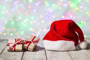 santa hat with christmas gift boxes against bokeh background photo