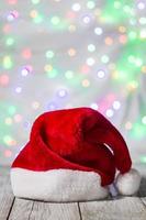 Red and white santa hat against bokeh background photo