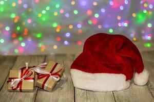 santa hat with christmas gift boxes against bokeh background photo