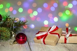 Gift boxes and colorful decorated Christmas tree on bokeh background with copy space photo