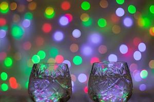 two glasses of champagne against bokeh lights background photo