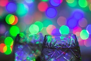 two glasses of champagne against bokeh lights background photo