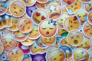 Ternopil, Ukraine - May 8, 2022 Large set of stickers with Emoji yellow faces. Sleep pictogram in focus photo