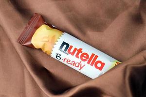 Ternopil, Ukraine - April 24, 2022 Bar of Nutella B-ready crunchy wafer shell filled with creamy Nutella and sprinkled with puffed crisps photo