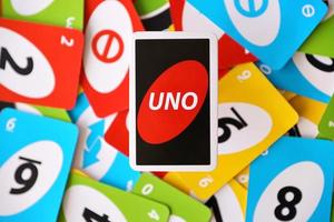 Ternopil, Ukraine - May 8, 2022 Many colorful UNO game cards. UNO is an American shedding-type card game that is played with a specially printed deck photo