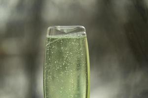 Shampoo in clear bottle. Glass detergent. Soapy substance. photo