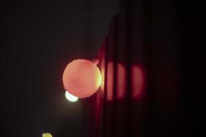 Red ball at construction site. Light on fence. photo