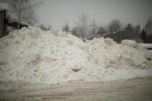 Snow on road. Big mountain of snow on highway. Result of cleaning road. photo