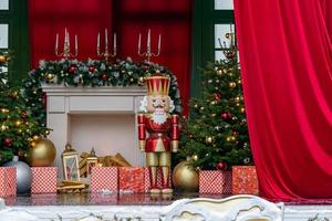 Theatre stage with new year decorations. Fireplace, Nutcracker. giftboxes. Celebration christmas performance photo