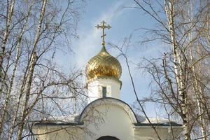 Orthodox church. Golden Dome. Religious building. Cross on roof. photo
