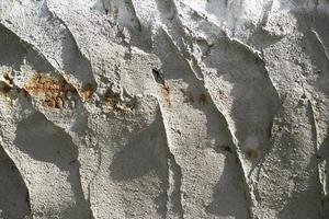 Texture of wall. Preparation of wall for repair. Scraped concrete. photo