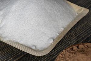 White sugar poured into a bowl photo