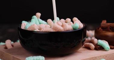 Pour milk into colorful corn sticks for a quick breakfast photo