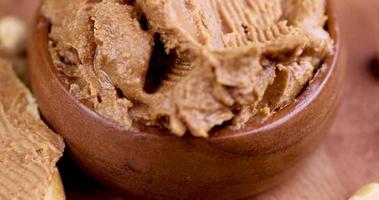 peanut butter with chunks of crushed peanuts and whole peanuts photo