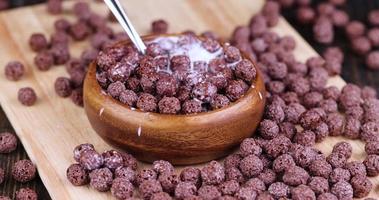 take chocolate balls in milk with a spoon photo