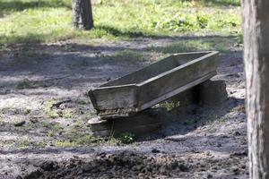 Wooden trough in the park for feeding herbivores photo