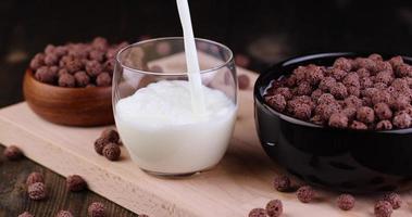 pour milk into a glass glass photo