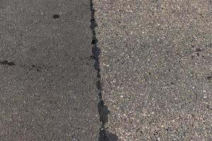 The repaired part of an asphalt road with patches photo