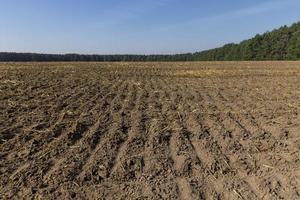 A plowed field with fertile soil for agricultural activities photo