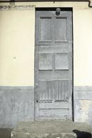 Old door in house. Gray front door in building. photo