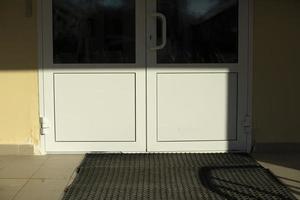 Entrance to building. Plastic white door to entrance. photo